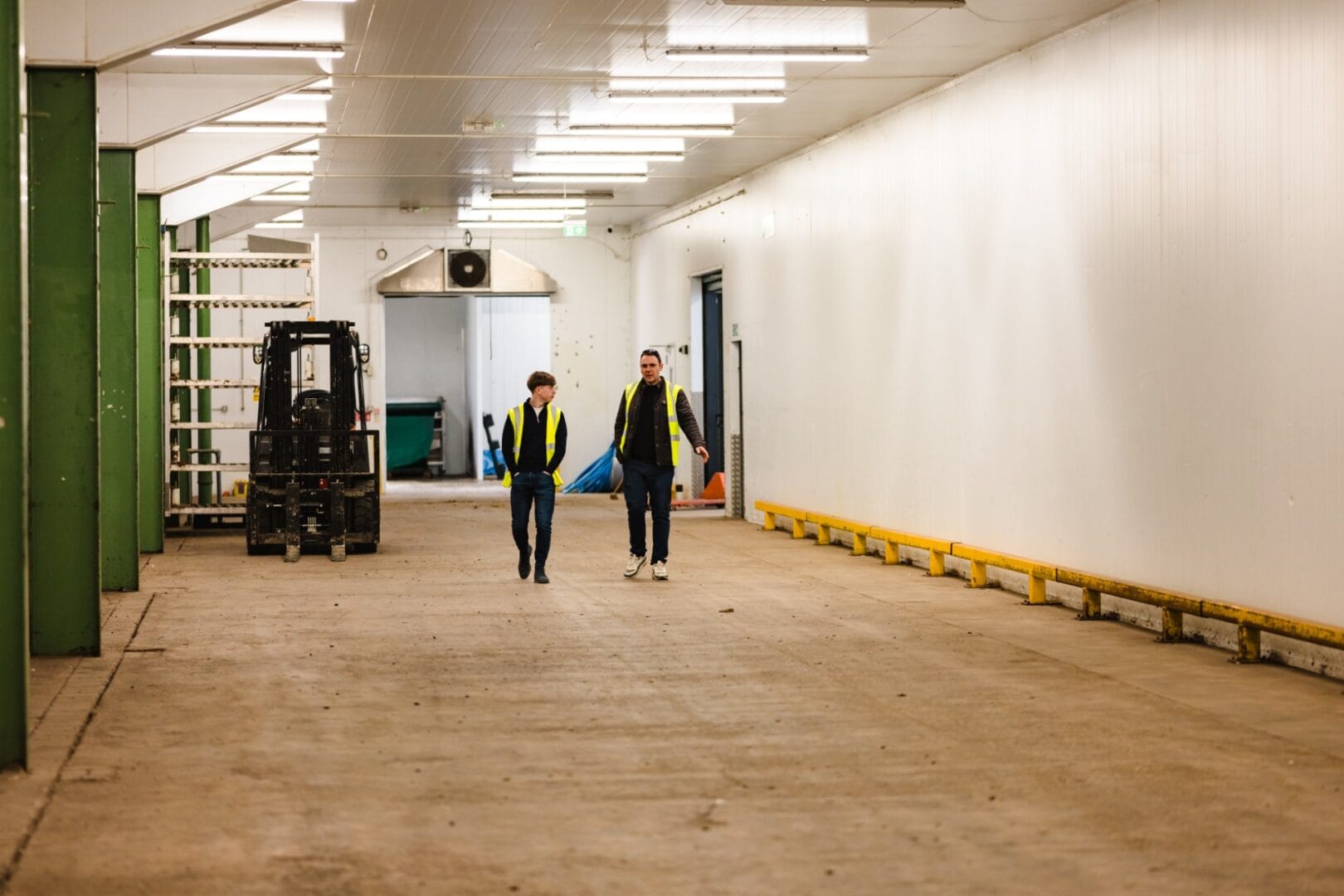 Two team members talking and walking