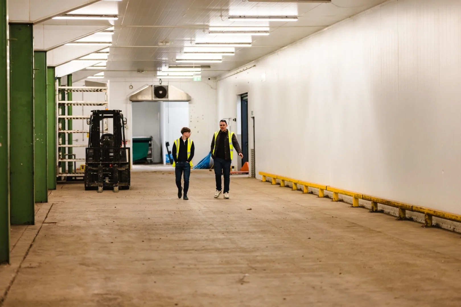 Two team members talking and walking