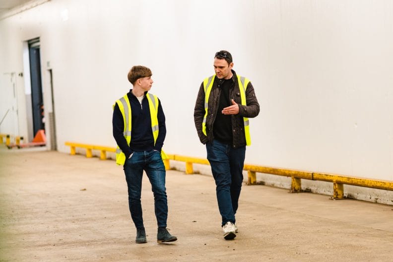 Two team members walking and talking together